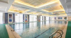 XinxiangにあるNew Century Grand Hotel Xinxiangの大きなお部屋(プール付)内の大きなスイミングプール