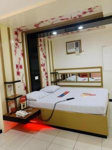 a bedroom with two beds and a basketball hoop at Hotel Sogo Tarlac in Tarlac +72 photos