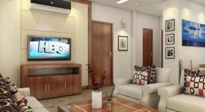 a living room with a couch and a television at Draco - Thang Long Hotel in Hai Phong