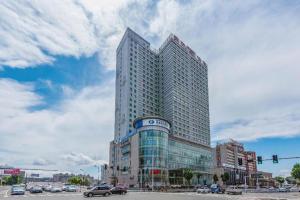 a tall building with a sign on the side of it at Yanji Yanbian International Hotel in Yanji