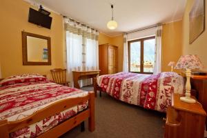 Ένα ή περισσότερα κρεβάτια σε δωμάτιο στο Albergo Valentino
