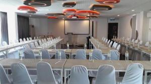 a conference room with tables and chairs and a screen at Eco Moment Beach Resort in Phetchaburi +210 photos