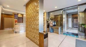 a lobby with a gold wall in a building at JinJiang Inn Datong Pingchengqiao in Datong