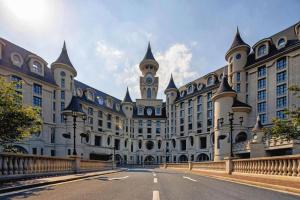 a large building with a clock tower on top of it at Yin Run Jin Jiang Castle Hotel in Huzhou