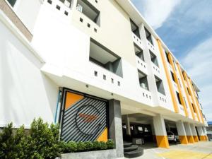 a white building with a painting on the front of it at The Circle Hotel in Buriram