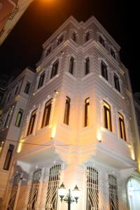 a large white building with lights on it at night at Bianco Residence Taksim in Istanbul