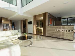 a living room with a couch and a table at B2 Ubon Premier Hotel in Ubon Ratchathani
