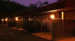 une maison avec des lumières sur son côté la nuit dans l'établissement Secret Garden Trang Resort, à Trang