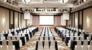 a conference room with white chairs and a large screen at Mungyeong saejae Resort in Mungyeong
