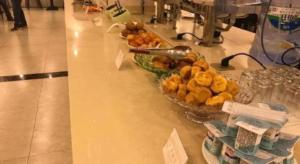 a counter with a bowl of food on a table at GreenTree Alliance Yichun Fengcheng Jianyi Avenue Hotel in Fengcheng