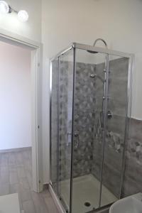 a shower with a glass door in a bathroom at B&B Mimì in Castelsardo +20 photos