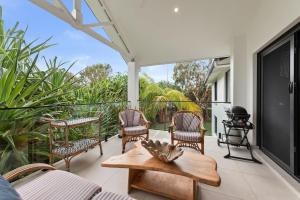 a patio with chairs and a grill and a table at Atlantis 6 - 70 Lawson Street in Byron Bay