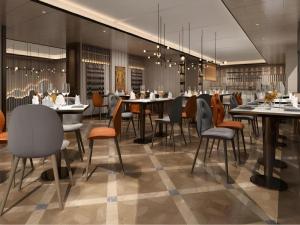 a restaurant with tables and chairs in a room at Metropolo Hotel Chengdu Wuhou Wanda Plaza in Chengdu