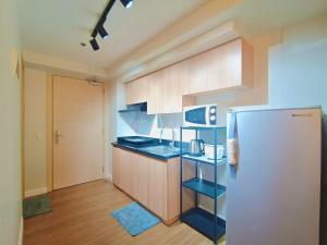 une cuisine avec un réfrigérateur et un micro-ondes dans l'établissement 1203BT3 Solinea Resort Condo Unit Queen Bed Ayala Center, à Cebu