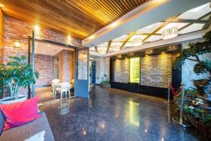 a lobby with a red brick wall at Pohang Hotel View in Pohang