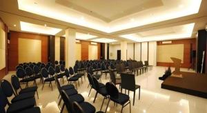 a large room with chairs and a podium in a room at Hotel Harmoni Tasikmalaya in Tasikmalaya