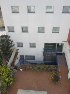 a building with blue benches in front of it at Hotel Blauet by Bossh Hotels in El Prat de Llobregat