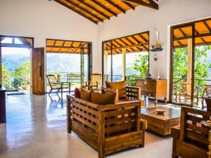 a living room with a couch and a table at Aqua Dunhinda Villa in Kandy