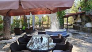 a fountain in a patio with chairs and a table at Charming Villa in Moniatis, Cyprus - Private Pool Garden in Saittas
