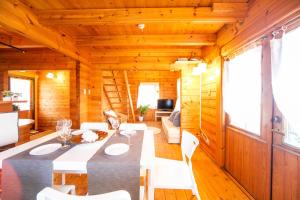 a dining room with a table and chairs in a cabin at [Sumoto City] Log house Gosyokumachi1 - Vacation STAY 14162 in Sumoto