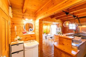 a kitchen with wooden walls and wooden floors at [Sumoto City] Log house Gosyokumachi1 - Vacation STAY 14162 in Sumoto +24 photos