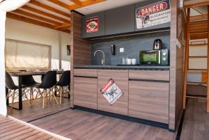 a kitchen with a counter and a table with chairs at T-Rex Glamping in Dubai
