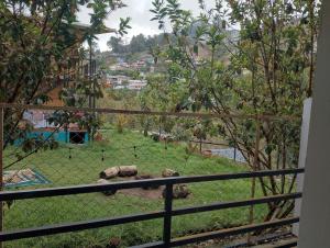 a view of some animals in a field behind a fence at Misty Valley Inn in Kodaikānāl +56 photos