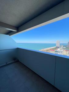 an empty room with a view of the ocean at Luxury Suite with Sea & PANORAMA View - Alliance Palace in Batumi