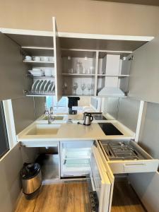 a small kitchen with a sink and a counter at Luxury Suite with Sea & PANORAMA View - Alliance Palace in Batumi