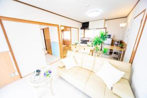 a living room with a couch and a table at Awaji Central house in Kusumoto - Vacation STAY 77607v in Awaji