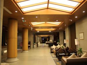 a lobby with couches and chairs in a building at Huangshan Xuanyuan International Hotel in Huangshan +254 photos