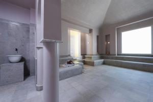 a large bathroom with a sink and a large window at Iberostar Selection Diar El Andalous in Port El Kantaoui