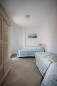 Voodi või voodid majutusasutuse Le 9 Gocce Seaview Apartment toas