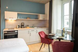 cocina con mesa y sillas rojas en una habitación en Das Adler, en Markdorf 44 fotos más