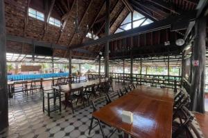 a room with tables and chairs in a building at Phuingfah in Chiang Mai