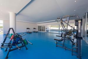 a gym with a swimming pool with tread machines at Iberostar Selection Diar El Andalous in Port El Kantaoui