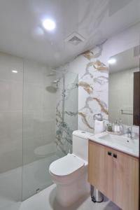 a bathroom with a toilet and a sink and a shower at ® {The~City~LUX~Place}@DowtownSD in La Julia