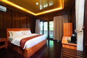 a bedroom with a large bed in a room at PS Bunaken Resort and Dive in Bunaken +45 photos