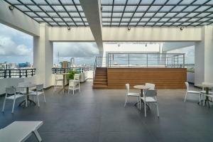 a restaurant with tables and chairs on a roof at ® {The~City~LUX~Place}@DowtownSD in La Julia