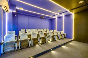 an empty room with white chairs and purple walls at ® {The~City~LUX~Place}@DowtownSD in La Julia +68 photos