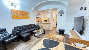 a living room with a couch and a table at Apartments KrAnJ - Family apartment Jurček in Kranj