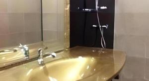 a bathroom with a sink with a mirror and a shower at UII Boutique Place in Sakon Nakhon