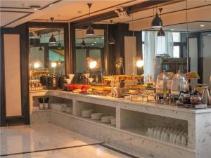 a kitchen with a counter with food on it at Xana Hotelle Lhasa Potala Palace Beijing Middle Road in Lhasa