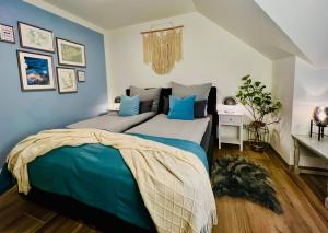 a bedroom with two beds with blue walls at INTERGO Apartments in Brackel