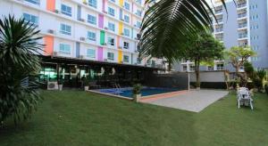 a large building with a pool in front of it at Royal King Suite in Bang Bo