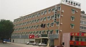 a large building with cars parked in front of it at GreenTree Inn Jinan Bus Terminal in Jinan
