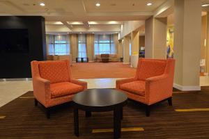 a lobby with two chairs and a table and a waiting room at Country Inn & Suites by Radisson, Convention Center in Altoona