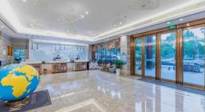 a large room with a large globe on the floor at Kyriad Marvelous Hotel Yiyang Xiufeng Park in Yiyang