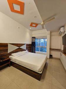 a bedroom with a large bed and a window at Golden Keys in Bengaluru