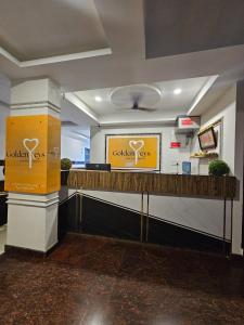 a lobby with a counter with a sign on it at Golden Keys in Bengaluru